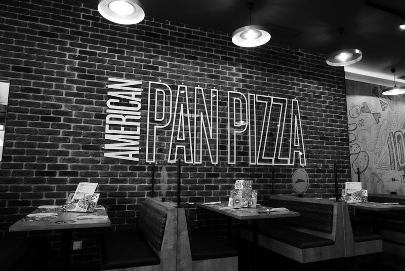 Inside Anthony's coal fired pizza restaurant — warm dining atmosphere